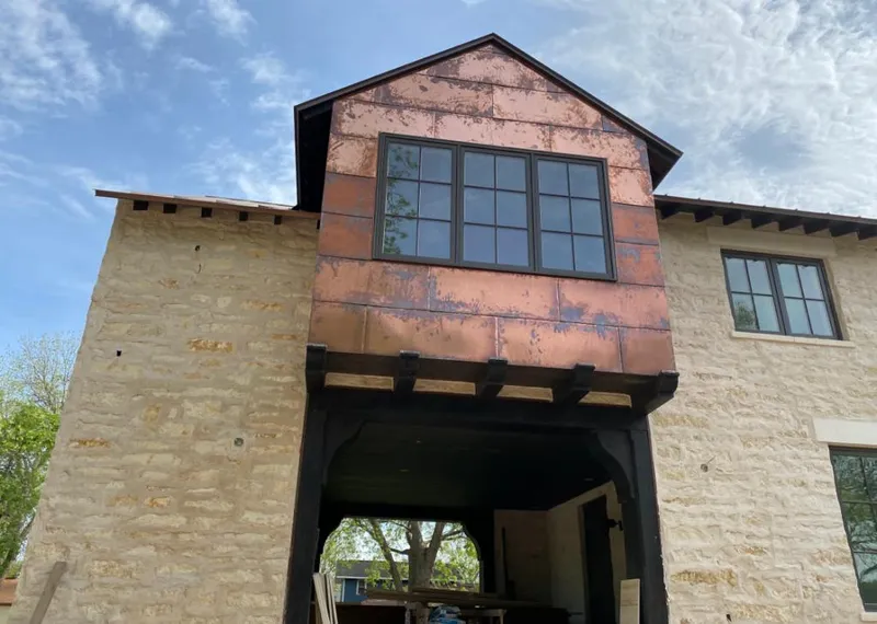 Copper metal panel facade on a stone building for Roof Repair in Bridgeview