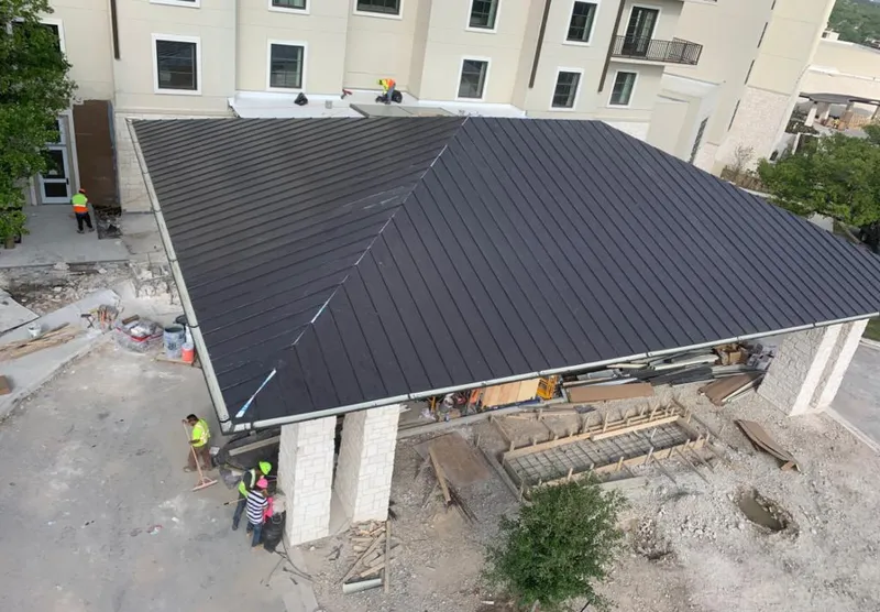 Metal roofing installation team working on a commercial building in Bridgeview