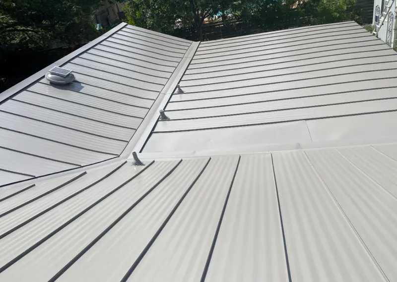 Solar attic fan installed on a metal roof for Roof Ventilation in Bridgeview